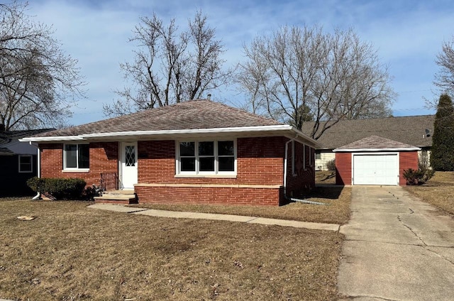 view of front of house featuring an outbuilding, brick siding, driveway, and a front lawn