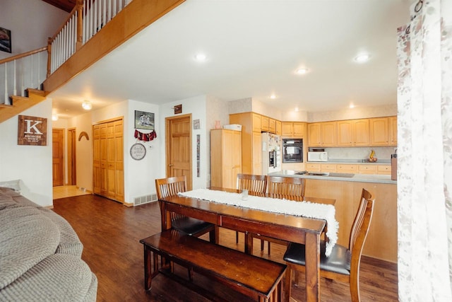 dining room featuring baseboards, visible vents, dark wood finished floors, recessed lighting, and arched walkways