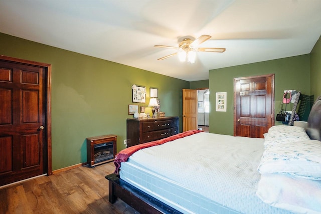 bedroom with ceiling fan, baseboards, and wood finished floors