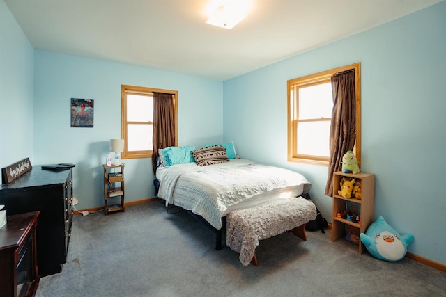 bedroom featuring baseboards and carpet