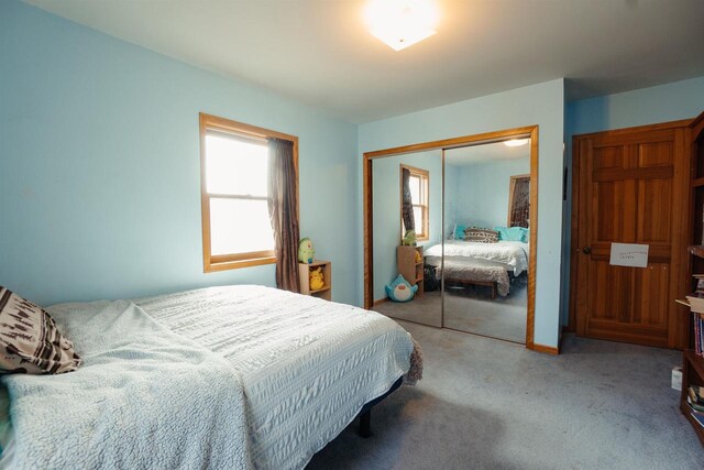 bedroom featuring a closet and light colored carpet