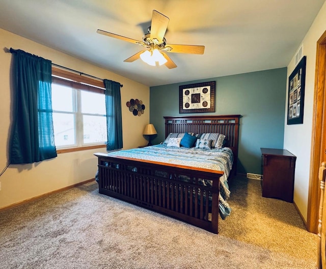 bedroom featuring a ceiling fan, visible vents, carpet, and baseboards