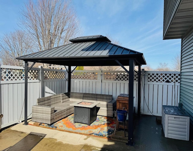 view of patio with a gazebo, an outdoor living space with a fire pit, and fence