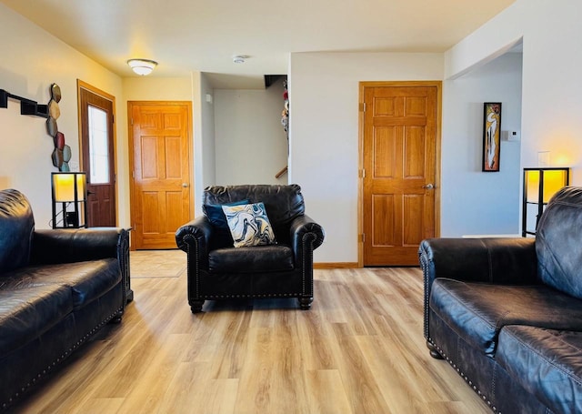 living room with light wood finished floors and baseboards