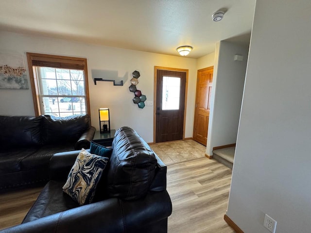 entryway featuring light wood-type flooring and baseboards