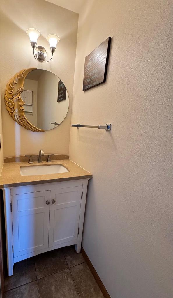 bathroom with tile patterned floors, vanity, and baseboards