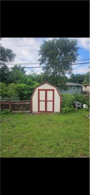 view of shed featuring fence