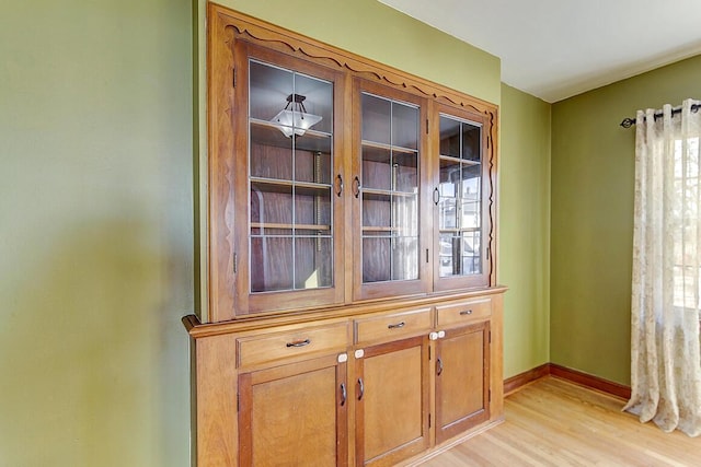 room details with baseboards and wood finished floors