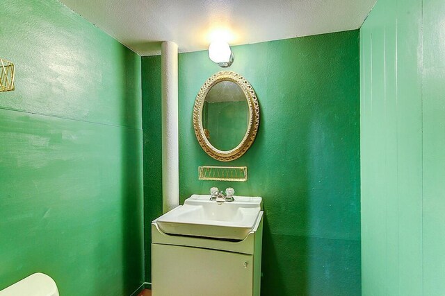 half bathroom featuring toilet and vanity