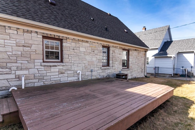 wooden terrace featuring cooling unit and fence