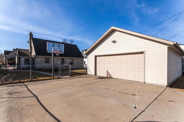 exterior space with an outbuilding, fence, and a garage