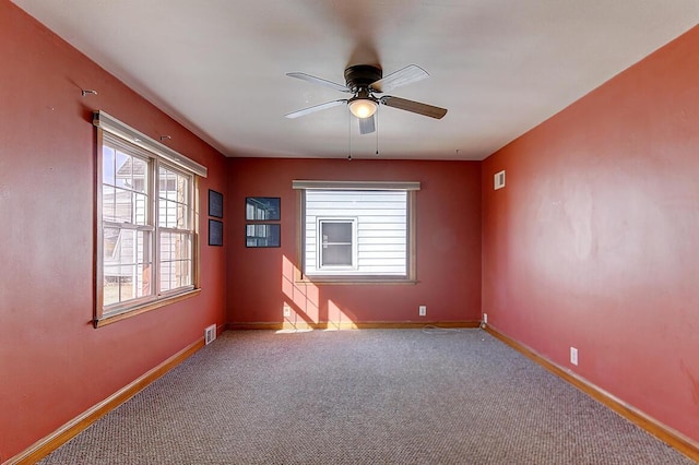 empty room with visible vents, carpet flooring, and baseboards