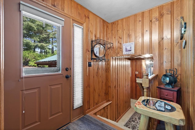 foyer with wood walls