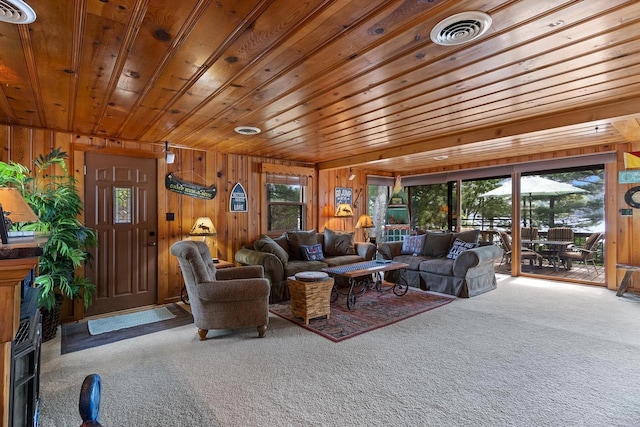 carpeted living room with visible vents, wooden walls, and wooden ceiling