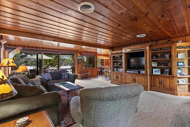 living room featuring visible vents, carpet, wooden ceiling, and wood walls