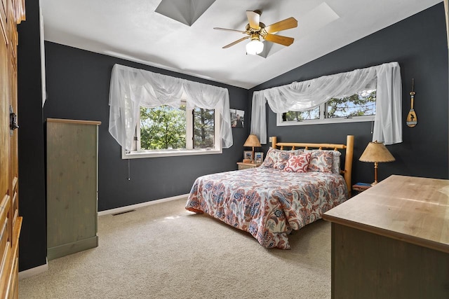 carpeted bedroom featuring lofted ceiling, multiple windows, visible vents, and baseboards