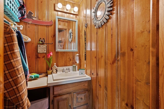 bathroom featuring vanity and wooden walls