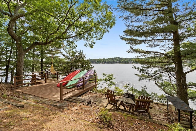 exterior space featuring a deck with water view