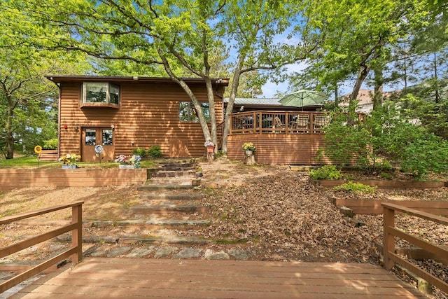 view of front of property featuring log veneer siding and a deck