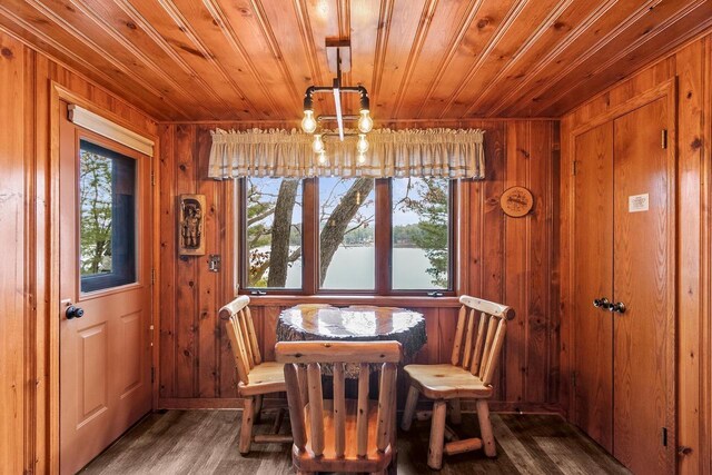 674 E Hiawatha Dr, Wisconsin Dells, WI 53965 - dining area with wood walls, an inviting chandelier, wood finished floors, and wood ceiling