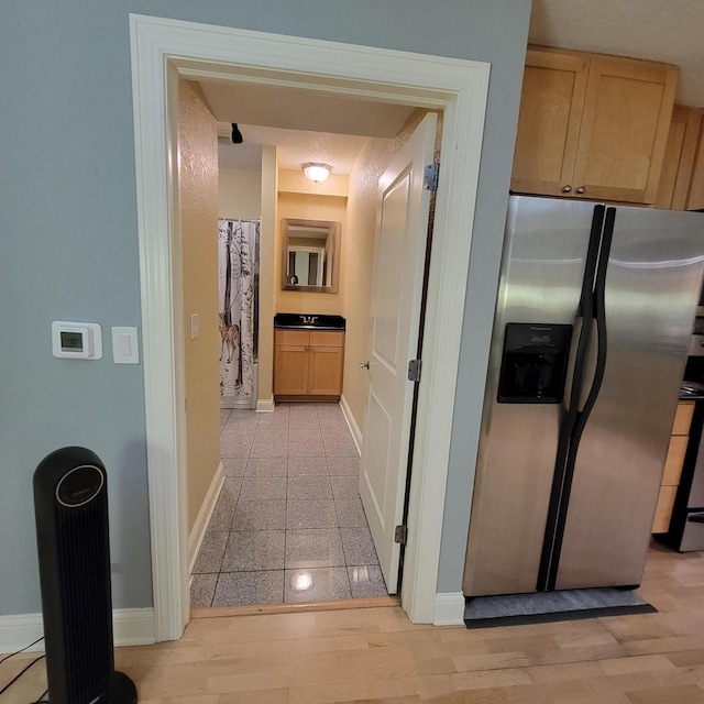 hall featuring granite finish floor and baseboards