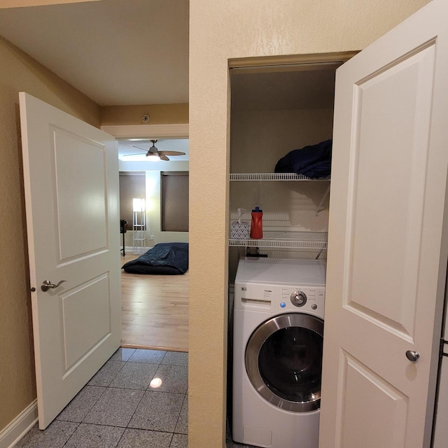 laundry room with a ceiling fan, washer / clothes dryer, granite finish floor, baseboards, and laundry area