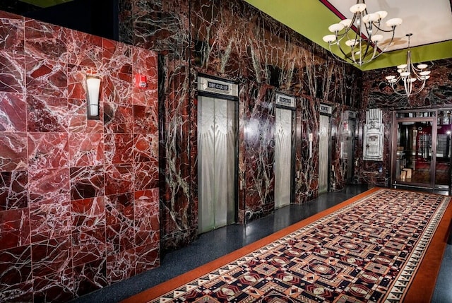 interior space with elevator and an inviting chandelier