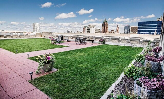 view of yard featuring a view of city and a patio area