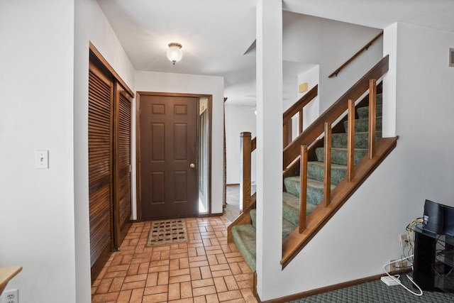 entrance foyer with brick floor and stairway