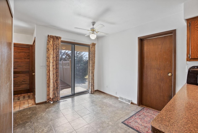 unfurnished dining area featuring visible vents, baseboards, and a ceiling fan