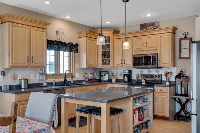 kitchen featuring light brown cabinets, stainless steel appliances, open shelves, and a sink