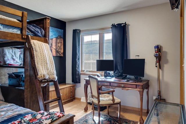 bedroom featuring wood finished floors and baseboards