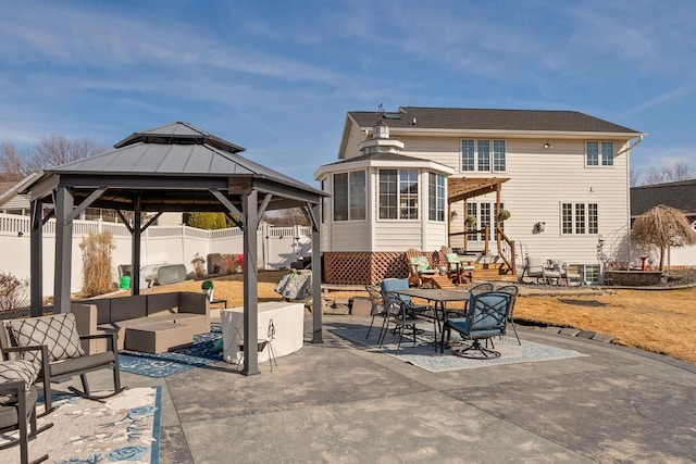 view of patio with an outdoor living space, entry steps, a gazebo, and fence