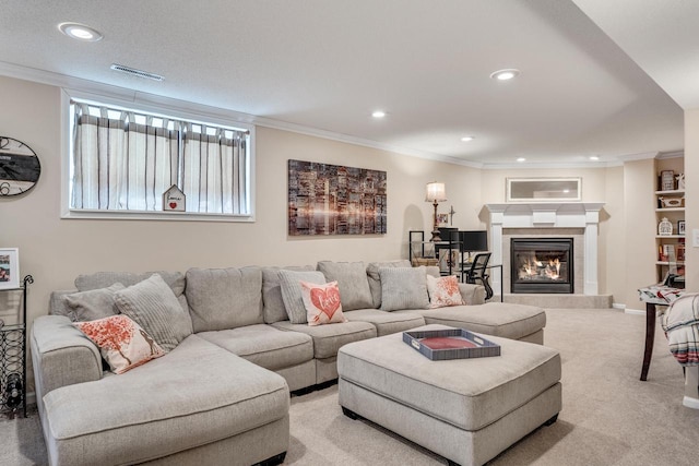 living area featuring visible vents, a tiled fireplace, recessed lighting, crown molding, and light colored carpet