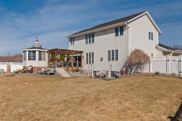 back of property featuring a patio, a gate, a fenced backyard, a pergola, and a lawn