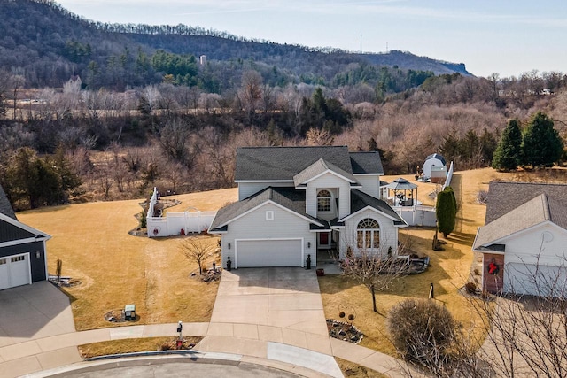 birds eye view of property featuring a mountain view and a view of trees