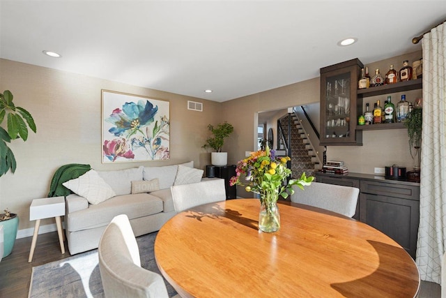 dining space featuring stairs, recessed lighting, wood finished floors, and visible vents