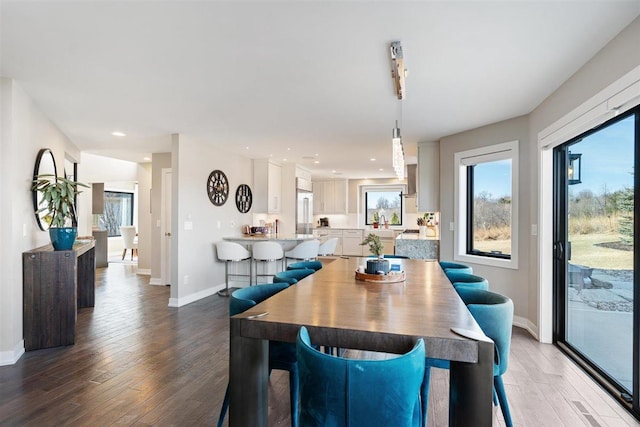 dining room featuring recessed lighting, wood finished floors, and baseboards