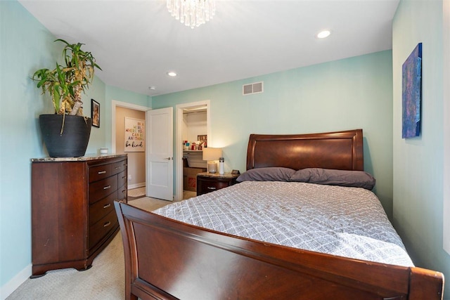 bedroom featuring baseboards, visible vents, recessed lighting, a spacious closet, and light carpet