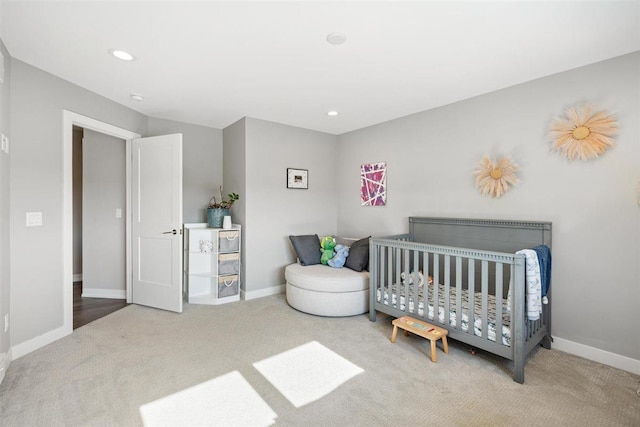 carpeted bedroom featuring recessed lighting and baseboards