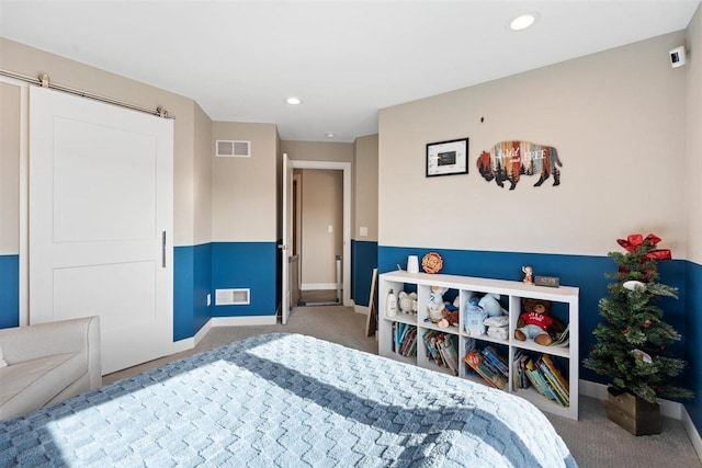 bedroom with a barn door, carpet flooring, recessed lighting, and visible vents