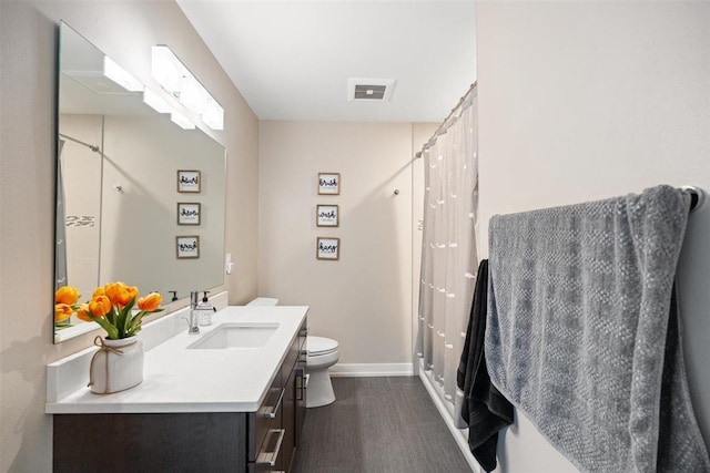 bathroom featuring visible vents, toilet, vanity, and a shower with shower curtain