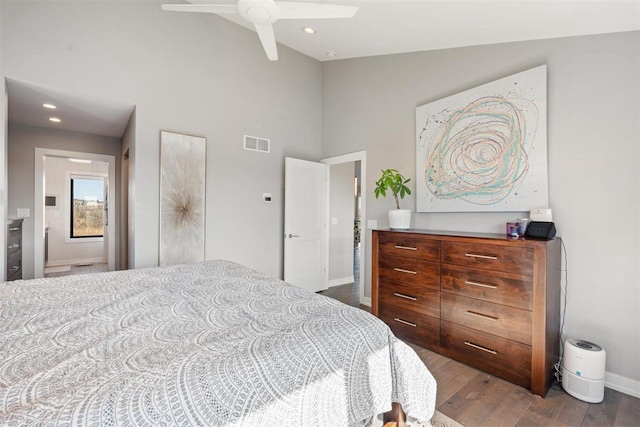 bedroom featuring recessed lighting, wood finished floors, visible vents, and high vaulted ceiling