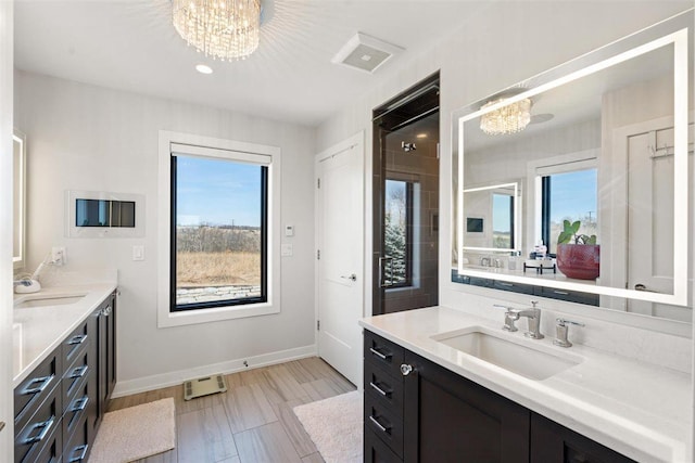 bathroom with a chandelier, plenty of natural light, and a sink