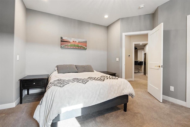 bedroom with recessed lighting, baseboards, and light carpet