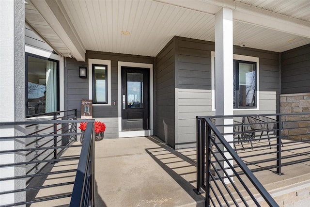 property entrance with stone siding and covered porch