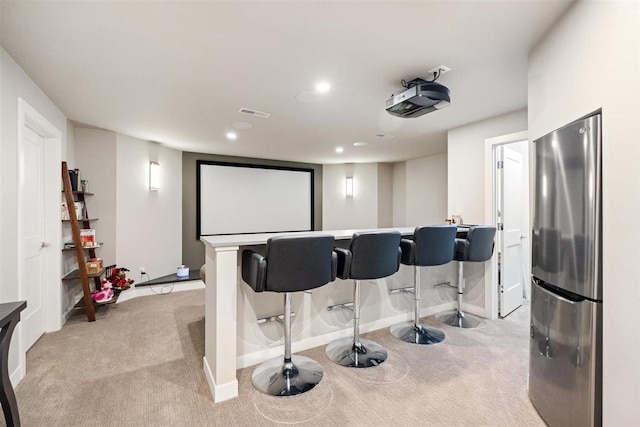 cinema featuring recessed lighting, baseboards, light carpet, and a dry bar