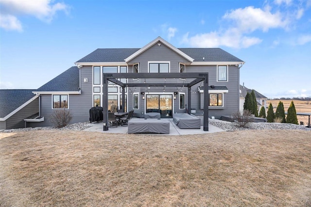 back of house featuring a patio, a yard, a pergola, and a shingled roof