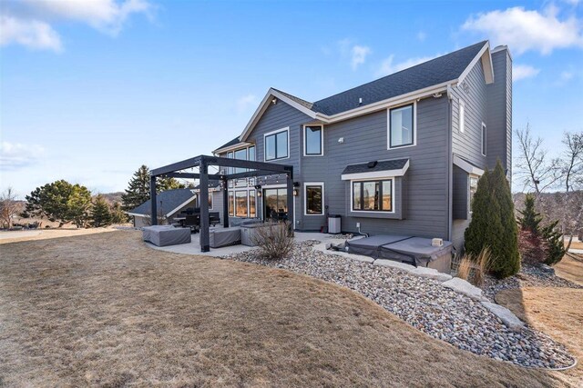 rear view of house featuring central AC, a pergola, and a patio area