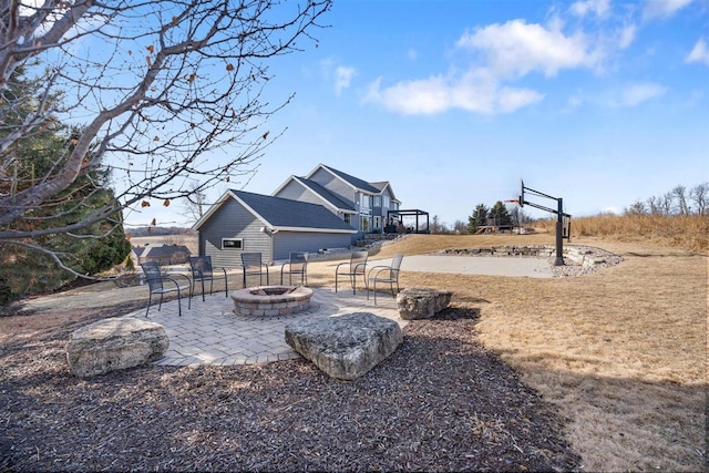 view of yard featuring a fire pit and a patio